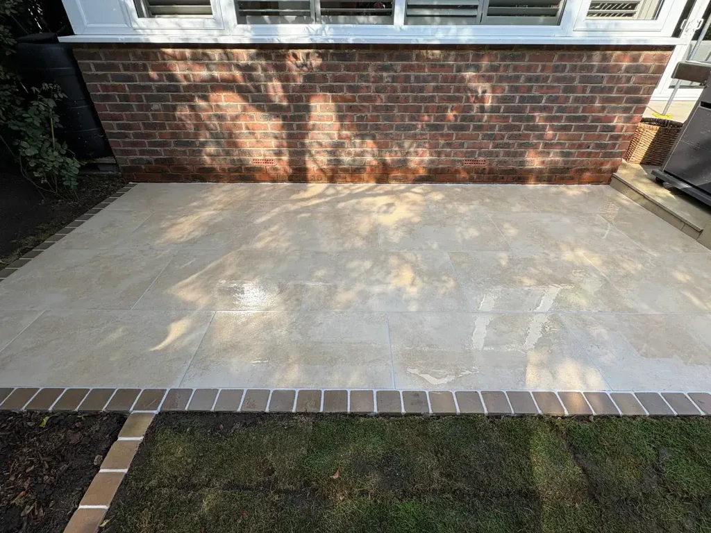 Detail of completed patio paving and contrasting brick edging.