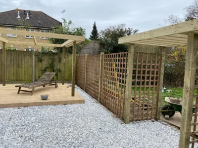 Side view of timber pergola posts, decking and trellis screening.